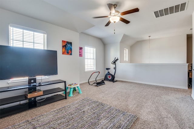 exercise room featuring carpet floors, ceiling fan, and vaulted ceiling