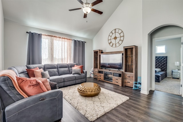 living room with ceiling fan, dark hardwood / wood-style floors, and high vaulted ceiling