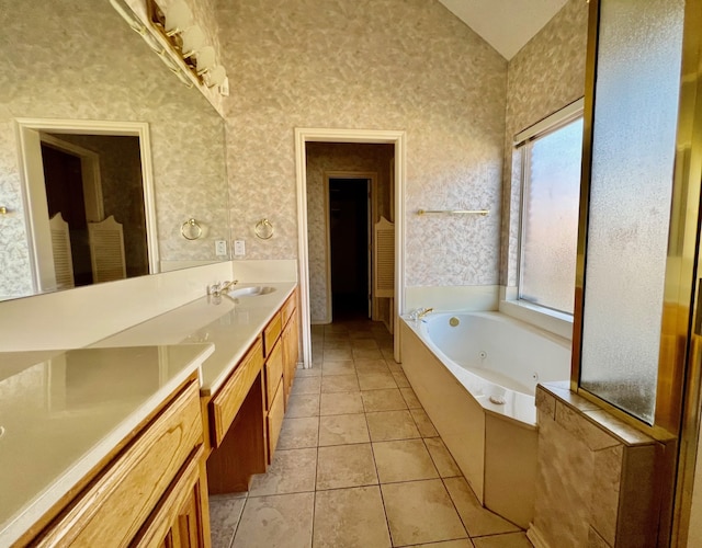 bathroom featuring vanity, a bath, and tile patterned floors