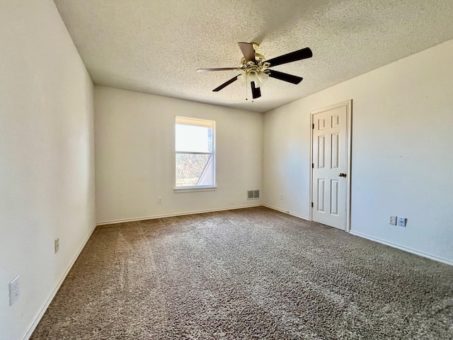 carpeted spare room with a textured ceiling and ceiling fan