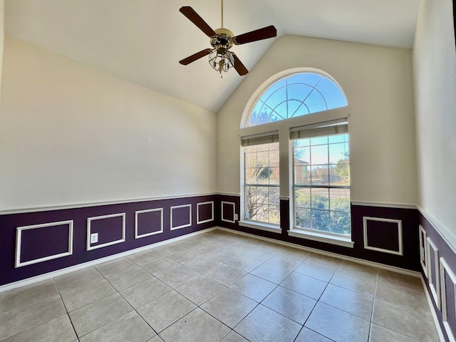 tiled empty room featuring high vaulted ceiling and ceiling fan