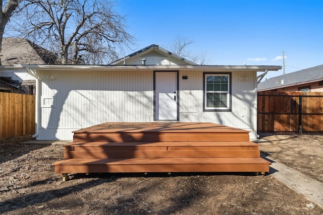 rear view of property featuring a hot tub