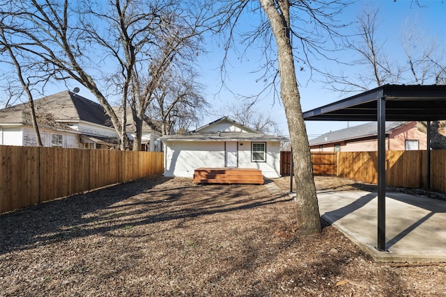 back of house with a hot tub and a patio