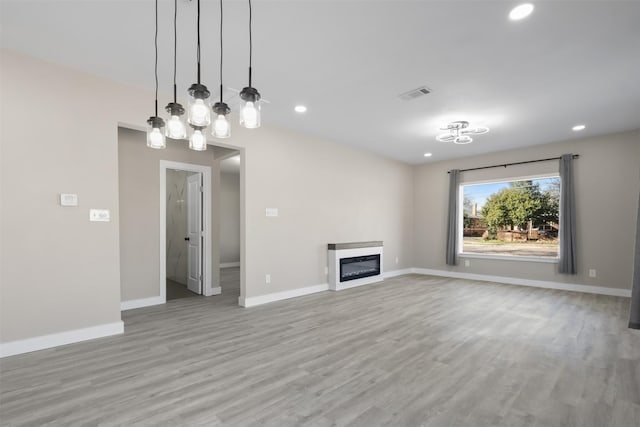 unfurnished living room featuring light wood-type flooring