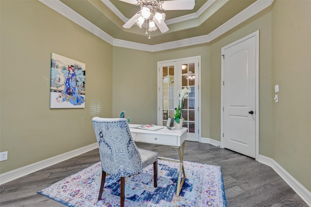 dining space featuring a tray ceiling, dark wood-type flooring, ornamental molding, and french doors