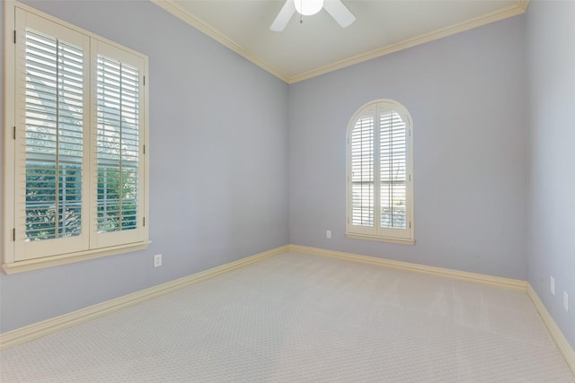 carpeted spare room with crown molding and ceiling fan