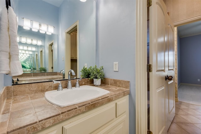 bathroom with crown molding, vanity, and tile patterned flooring