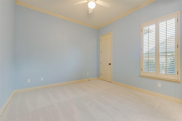 carpeted spare room featuring ornamental molding and ceiling fan