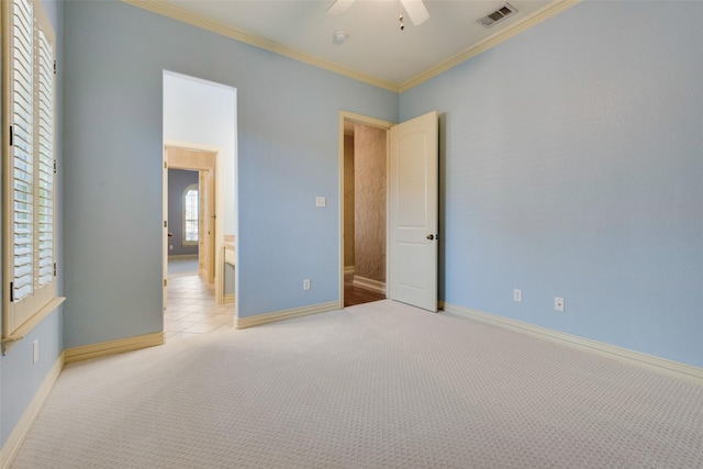 unfurnished bedroom with ceiling fan, light colored carpet, and ornamental molding