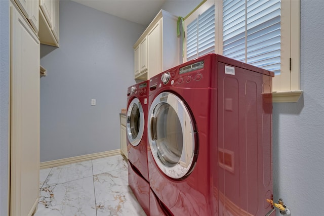 laundry area with cabinets and washing machine and dryer