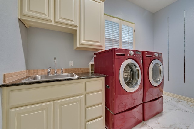 washroom with washer and dryer, sink, and cabinets