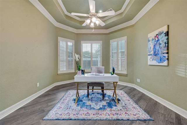 office featuring dark hardwood / wood-style floors, ceiling fan, ornamental molding, and a tray ceiling