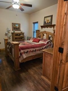 bedroom with dark wood-type flooring and ceiling fan