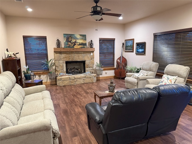 living room with ceiling fan, dark wood-type flooring, and a fireplace