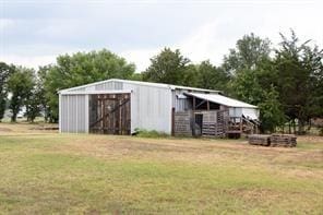 view of outbuilding featuring a yard