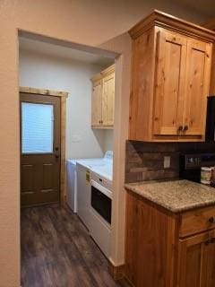 kitchen featuring dark hardwood / wood-style flooring, light stone counters, washer and clothes dryer, and decorative backsplash