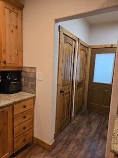 kitchen featuring dark hardwood / wood-style flooring and light stone counters