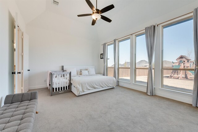 bedroom with a ceiling fan, visible vents, baseboards, lofted ceiling, and carpet flooring