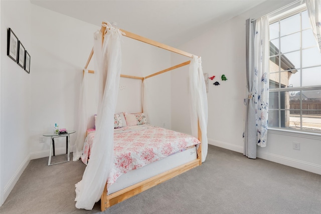 carpeted bedroom featuring baseboards