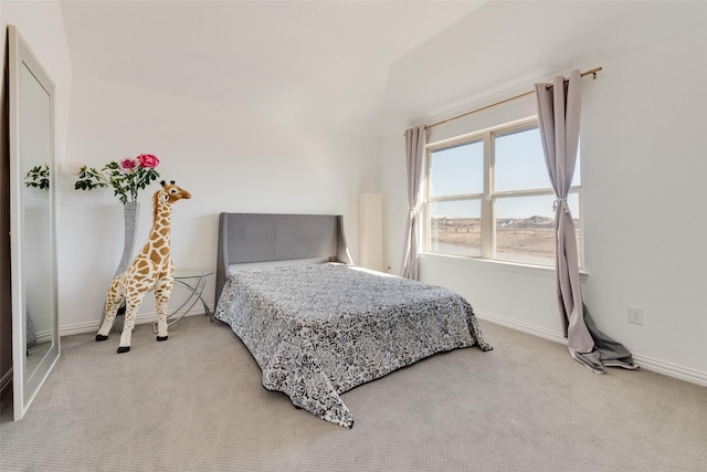 bedroom featuring baseboards and light carpet