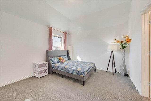 bedroom with baseboards and carpet
