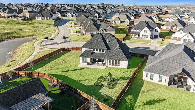 birds eye view of property with a residential view and a water view