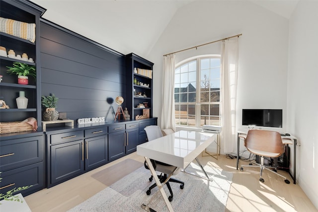 office space with light wood-type flooring and lofted ceiling