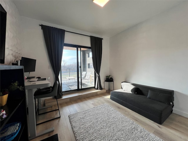 bedroom featuring baseboards and wood finished floors