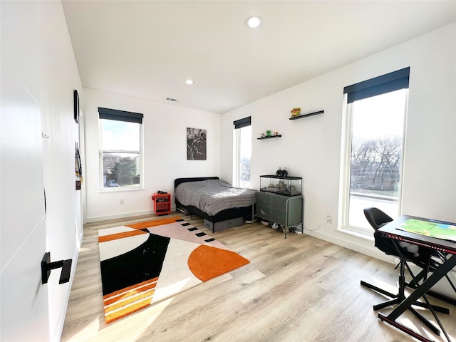 bedroom featuring recessed lighting, baseboards, wood finished floors, and visible vents