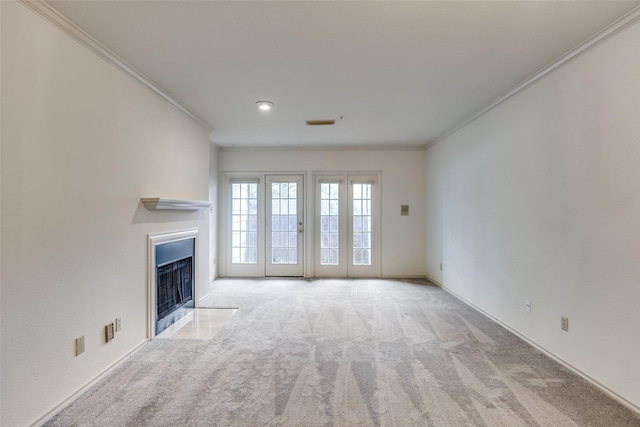 unfurnished living room with crown molding and light carpet