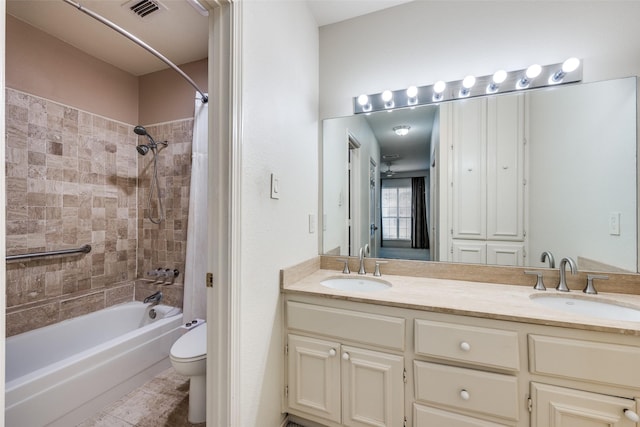 full bathroom featuring tiled shower / bath combo, vanity, tile patterned floors, and toilet