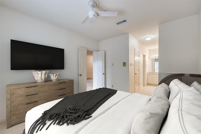 carpeted bedroom featuring ensuite bathroom and ceiling fan