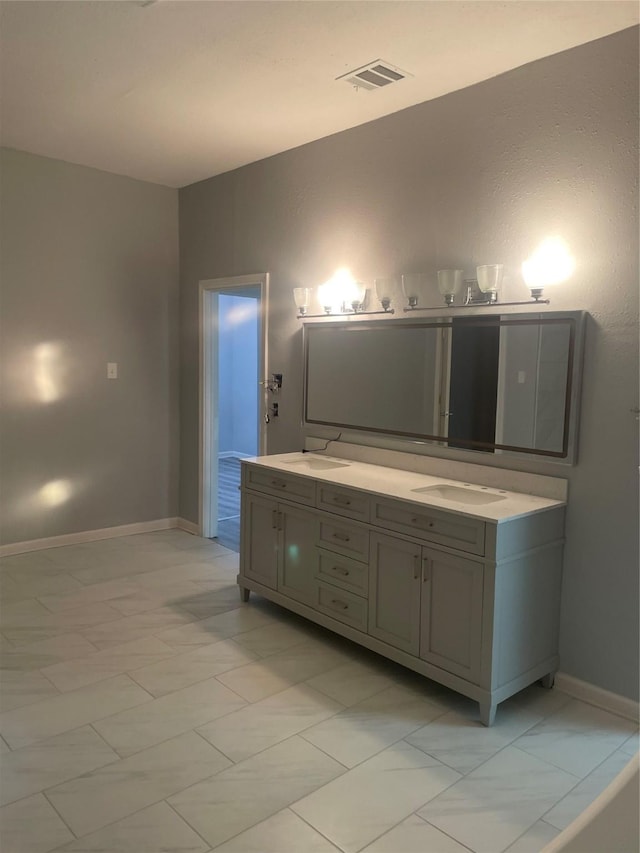 full bathroom featuring baseboards, visible vents, double vanity, a sink, and marble finish floor