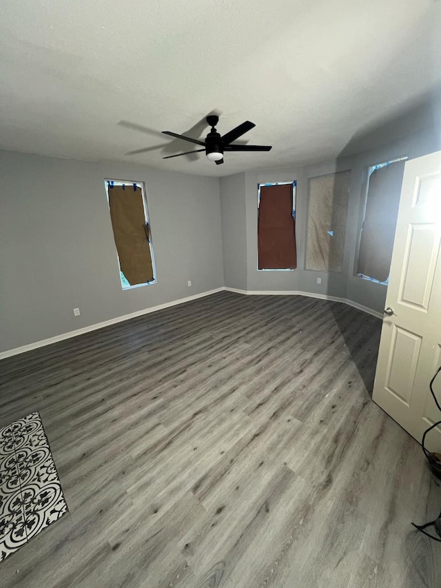 unfurnished room featuring a textured ceiling, wood-type flooring, and ceiling fan