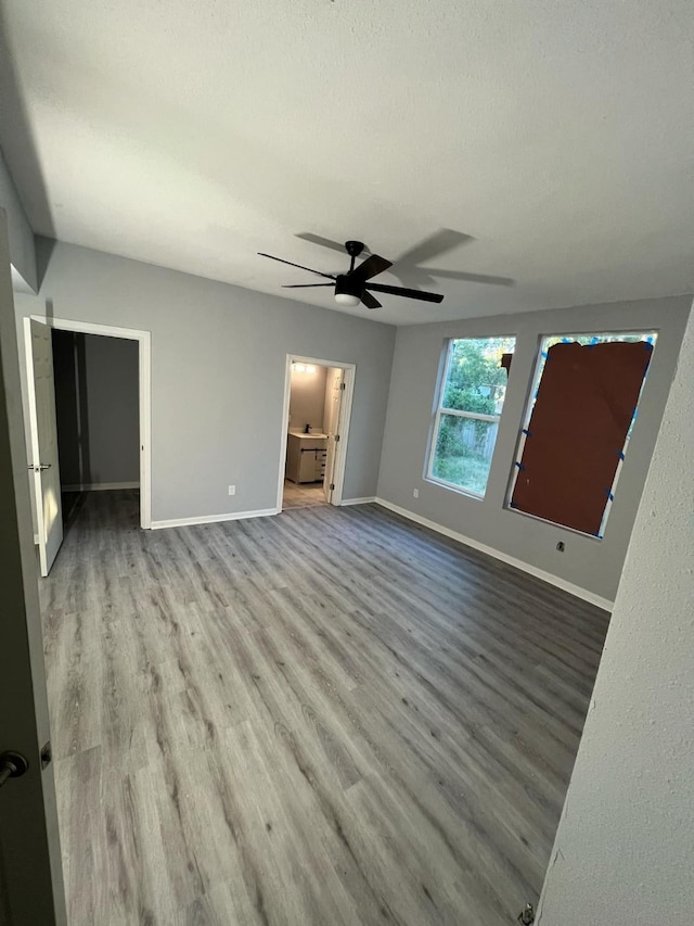 interior space featuring ceiling fan, light hardwood / wood-style floors, and a textured ceiling