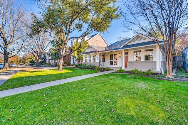 view of front of house with a front yard and covered porch