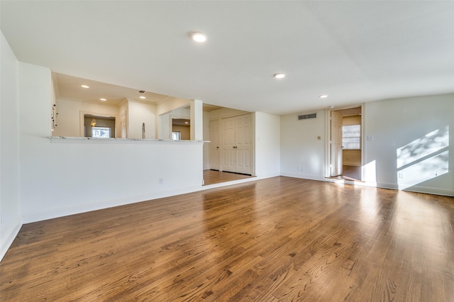 unfurnished living room with wood-type flooring