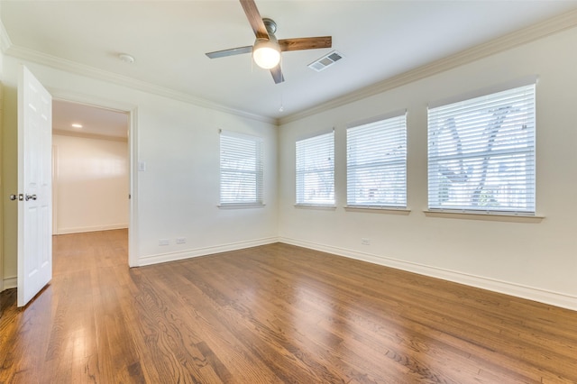 empty room with crown molding, dark hardwood / wood-style floors, and ceiling fan