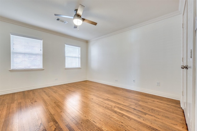 empty room with ornamental molding, ceiling fan, and light wood-type flooring