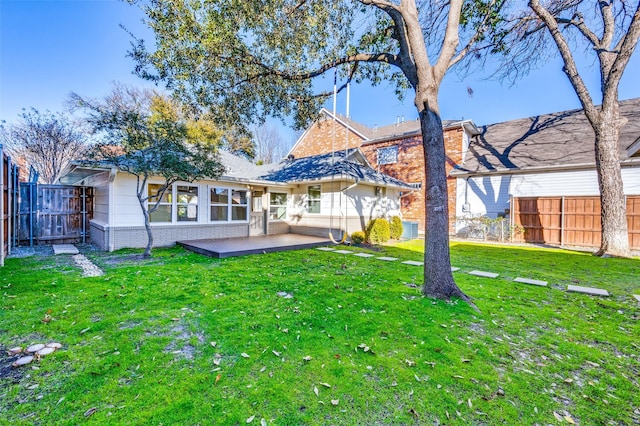 rear view of house with a lawn and a patio