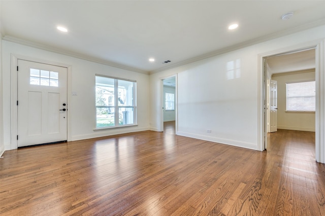 foyer featuring ornamental molding and hardwood / wood-style floors