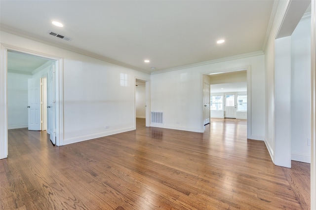 unfurnished room featuring ornamental molding and wood-type flooring