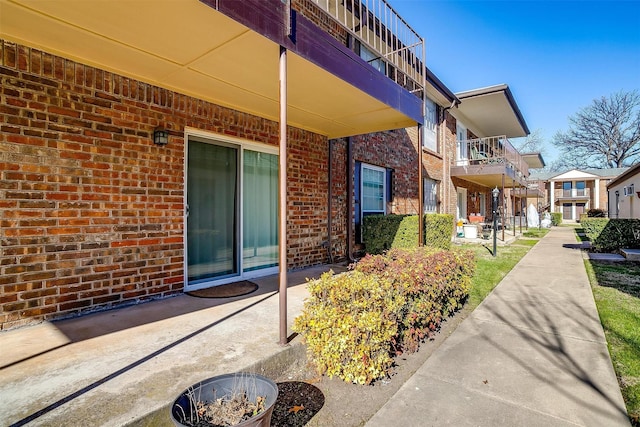 exterior space featuring brick siding