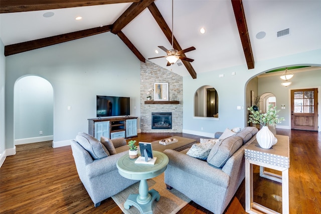 living room with dark wood-type flooring, a stone fireplace, high vaulted ceiling, beamed ceiling, and ceiling fan