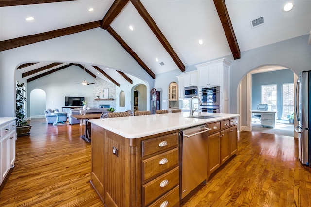 kitchen featuring sink, ceiling fan, appliances with stainless steel finishes, a kitchen island with sink, and white cabinetry