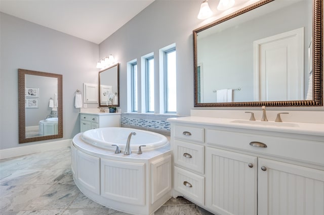 bathroom with vanity and a tub