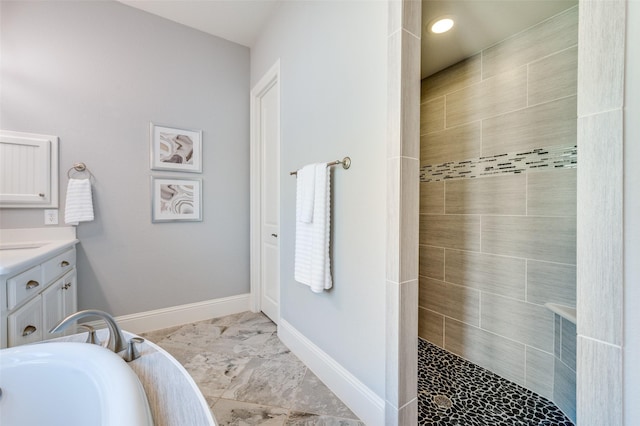 bathroom with vanity and tiled shower