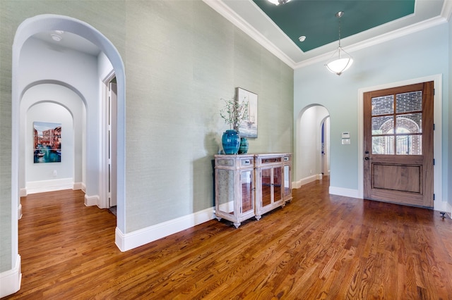 foyer featuring hardwood / wood-style flooring and crown molding