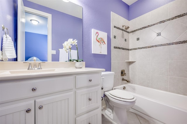 full bathroom featuring tiled shower / bath combo, vanity, tile patterned flooring, and toilet