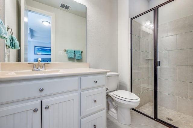 bathroom with tile patterned floors, vanity, toilet, and an enclosed shower